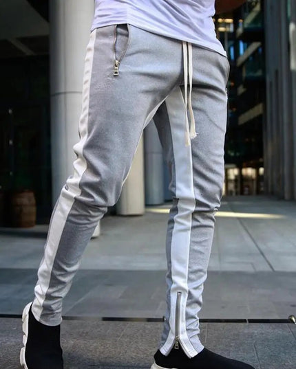 Sportowe dresy męskie z ozdobnym lampasem i suwakiem na nogawce