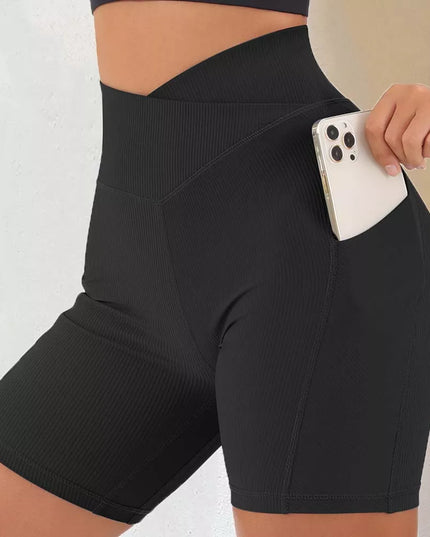 Sportowe legginsy damskie z wysokim stanem i kieszonką - krótki fason