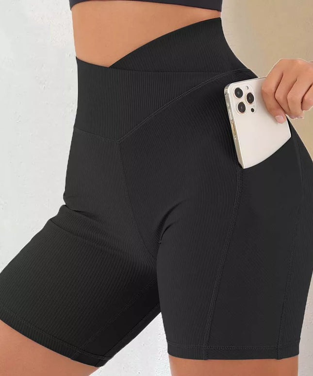 Sportowe legginsy damskie z wysokim stanem i kieszonką - krótki fason