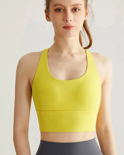 Sportowy top damski ze skrzyżowanymi ramiączkami i wszytymi miseczkami