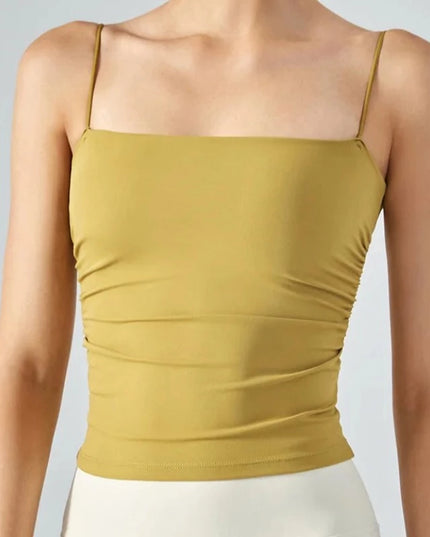 Sportowy top damski o bardzo dopasowanym kroju, na cienkich ramiączkach