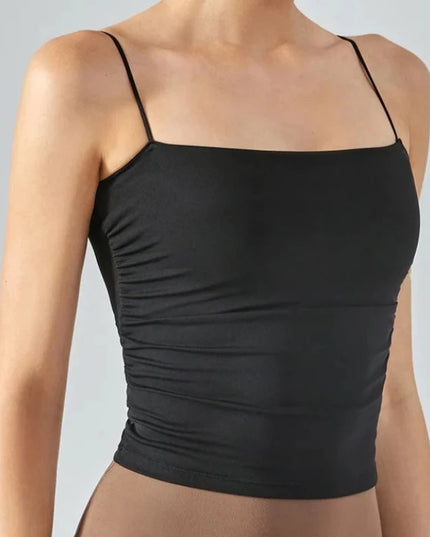 Sportowy top damski o bardzo dopasowanym kroju, na cienkich ramiączkach