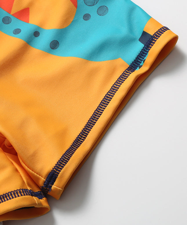 Kąpielówki dla chłopca pomarańczowe z dinozaurem