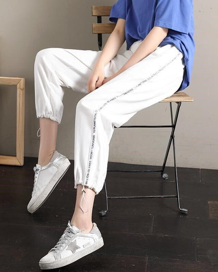 Damskie spodnie dresowe z napisami na nogawkach