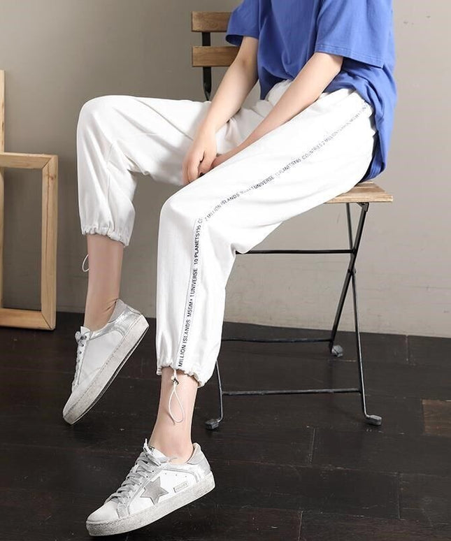 Damskie spodnie dresowe z napisami na nogawkach