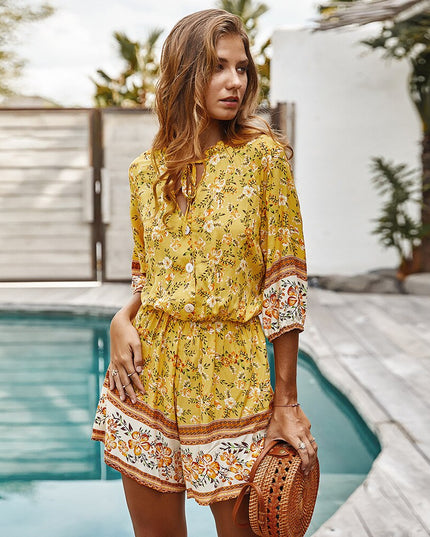 Damski kombinezon w kwiaty z rękawem 3/4