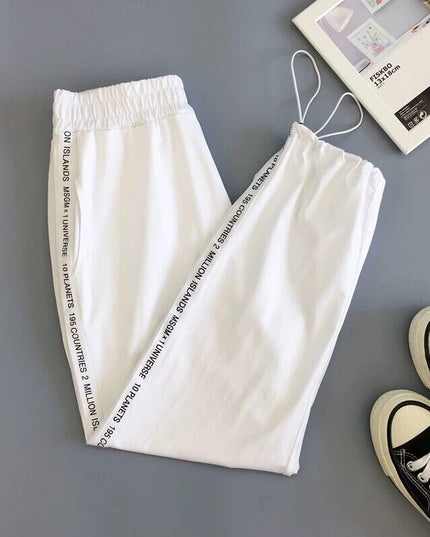 Damskie spodnie dresowe z napisami na nogawkach