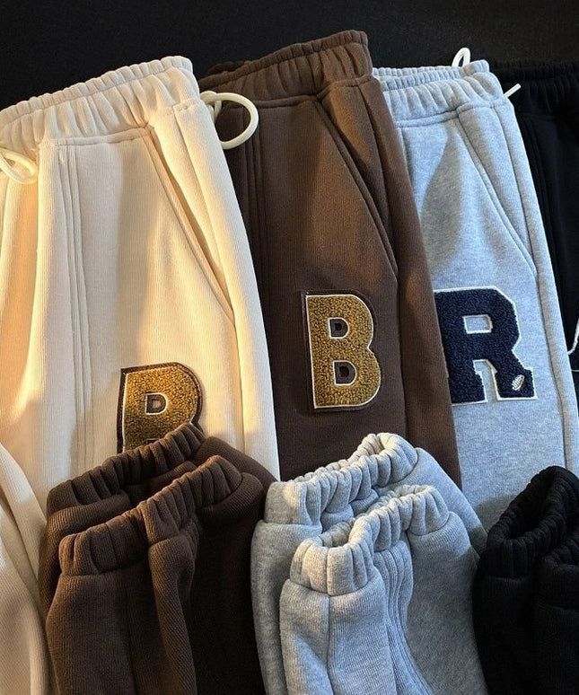 Damskie spodnie dresowe z naszywanymi literkami