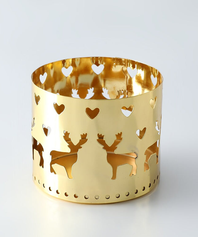 Świąteczny złoty świecznik z ażurowymi dekorami w kształcie reniferów