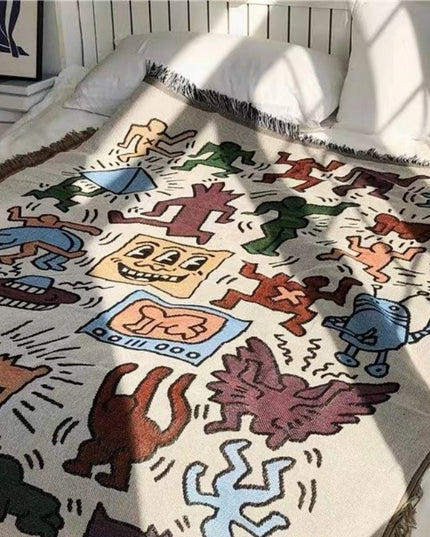 Pled z frędzlami w kolorowe rysunki