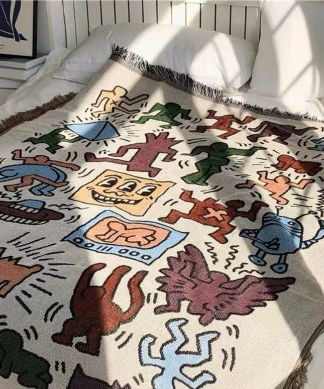 Pled z frędzlami w kolorowe rysunki