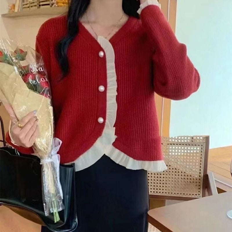 Damski sweter typu kardigan z falbanką
